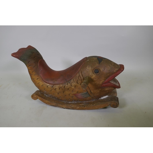 1066 - A carved and painted wood rocking dolphin, 62cm long