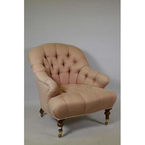 1070 - A Victorian style button back nursing chair, raised on turned mahogany supports with brass castors