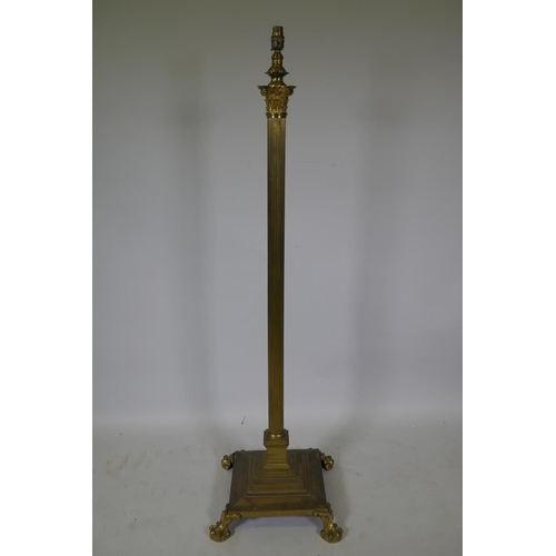 1072 - A brass Corinthian column floor lamp on platform base with claw feet, 135cm