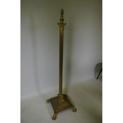 1072 - A brass Corinthian column floor lamp on platform base with claw feet, 135cm