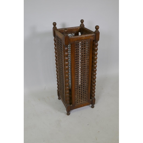 1074 - An antique oak umbrella/stick stand with cane panels, 28 x 28cm, 77cm high