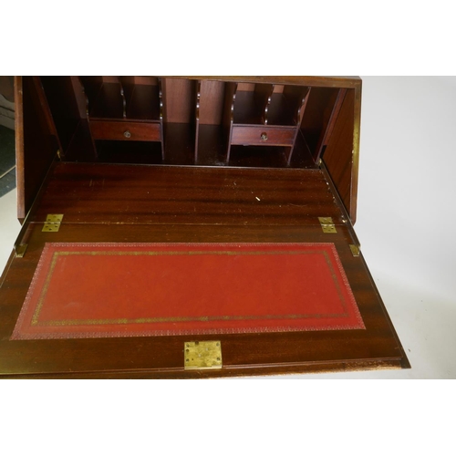 1076 - A Georgian style figured mahogany bureau, with fall front and fitted interior with inset leather fla... 