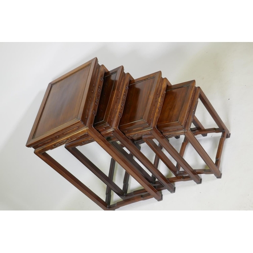 1084 - A Chinese rosewood nest of four occasional tables with finely carved friezes, raised on square suppo... 