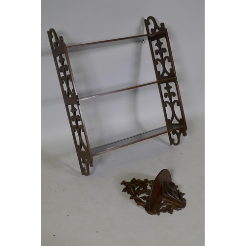 1085 - A three tier mahogany wall shelf with pierced fretwork sides, 51 x 15 x 65cm, and a carved and pierc... 