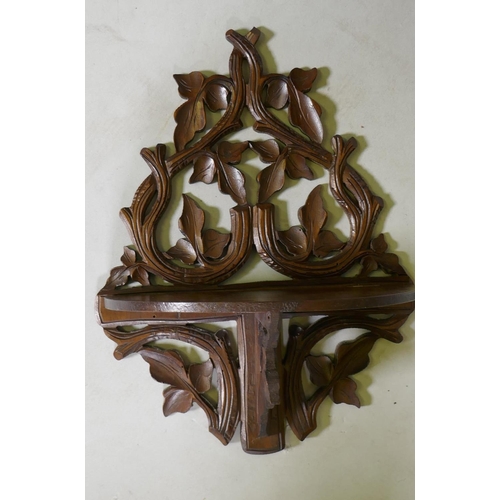 1085 - A three tier mahogany wall shelf with pierced fretwork sides, 51 x 15 x 65cm, and a carved and pierc... 