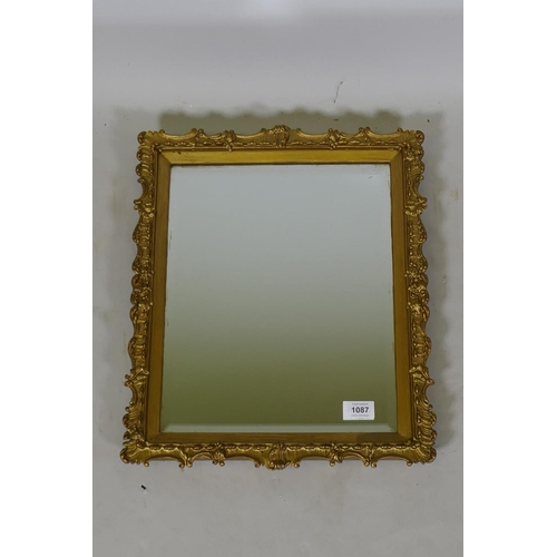 1087 - A giltwood and composition wall mirror with bevelled glass, late C19th/early C20th, 39 x 46cm