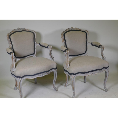 1091 - A pair of C19th French painted beechwood arm chairs with shaped backs and carved decoration, raised ... 