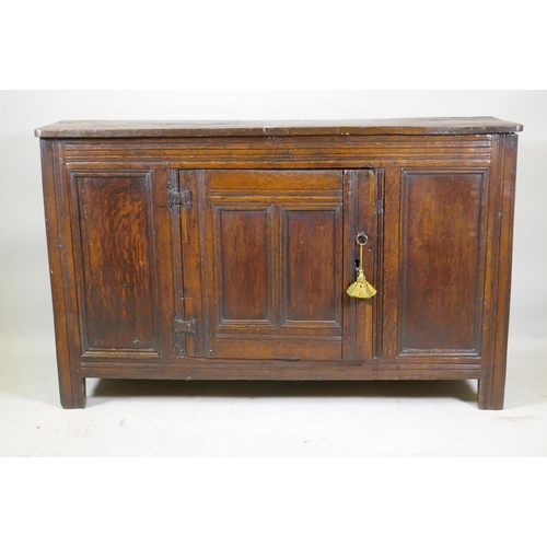 1093 - An C18th oak side cabinet with single panelled door cupboard and moulded details, 138 x 43 x 85cm, r... 