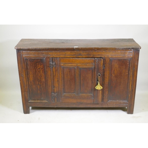 1093 - An C18th oak side cabinet with single panelled door cupboard and moulded details, 138 x 43 x 85cm, r... 