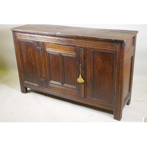 1093 - An C18th oak side cabinet with single panelled door cupboard and moulded details, 138 x 43 x 85cm, r... 