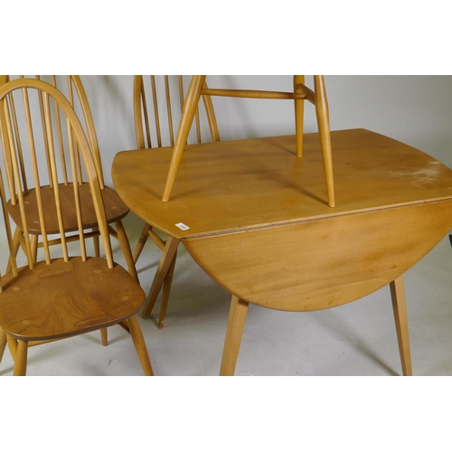 1099 - A mid C20th Ercol elm and beech dropleaf dining table, Model 384, and four Quaker chairs, Model 365,... 