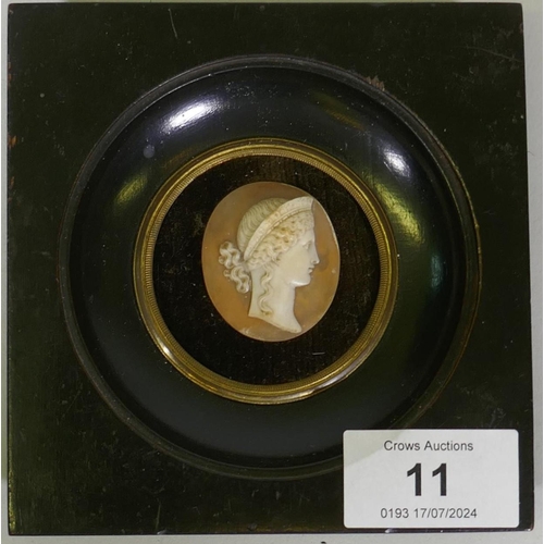 11 - An antique cameo of classical bust in profile, in an ebony and brass mounted frame, 11.5 x 10.5cm