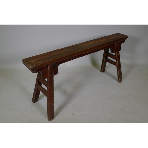 1105 - An antique Chinese elm topped bench, 105cm long