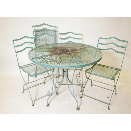 1115 - A vintage painted garden table and four matching folding chairs, 90cm diameter, 73cm high