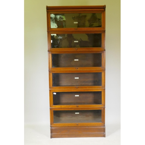 1129 - A Globe-Wernicke six section mahogany glazed bookcase, with base and top, 87 x 28 x 203cm