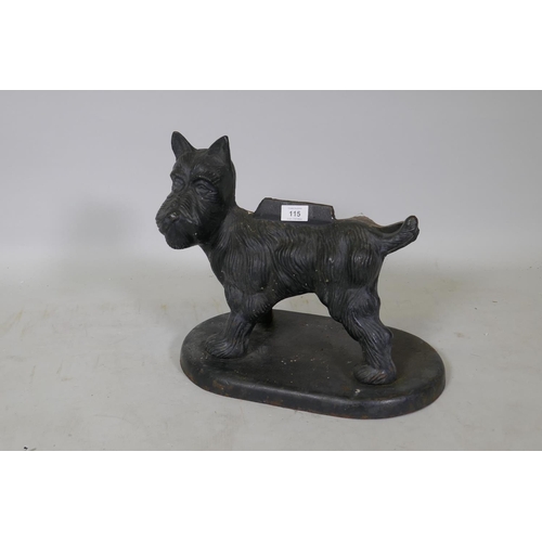 115 - A painted cast iron boot scraper in the form of a terrier cocking his back leg, 34cm high