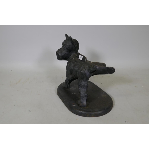 115 - A painted cast iron boot scraper in the form of a terrier cocking his back leg, 34cm high