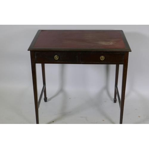 1153 - A Victorian mahogany two drawer writing table with inset faux leather top, raised on tapering suppor... 