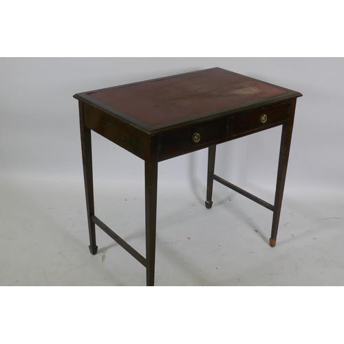 1153 - A Victorian mahogany two drawer writing table with inset faux leather top, raised on tapering suppor... 