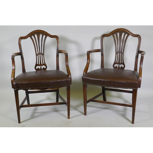 1173 - A pair of C19th Hepplewhite style elbow chairs with pierced splat backs and studded leather seats, r... 