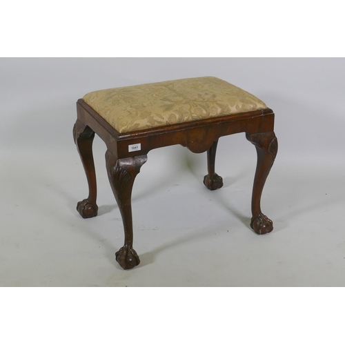 1182 - A Georgian style walnut foot stool raised on carved cabriole supports with claw and ball feet, 57 x ... 