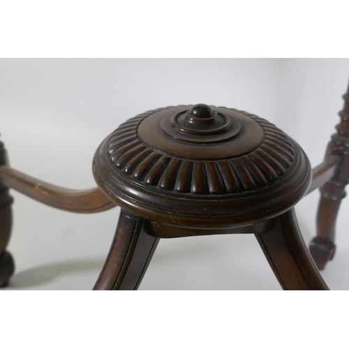 1196 - A Victorian mahogany envelope card table, raised on ring turned fluted supports with scroll ends, th... 