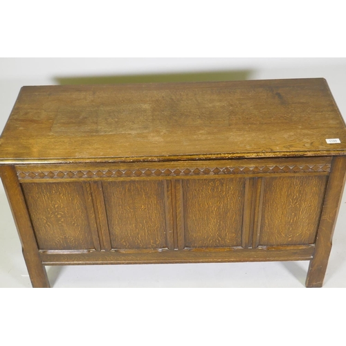 1199 - An oak coffer with four panel front, carved frieze and lift up top, mid C20th, 107 x 43 x 62cm