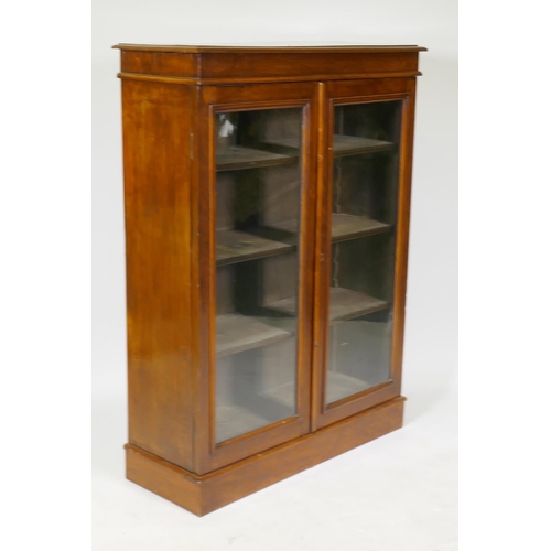 1204 - A Victorian mahogany two door glazed bookcase with adjustable shelves, 80 x 30 x 107cm