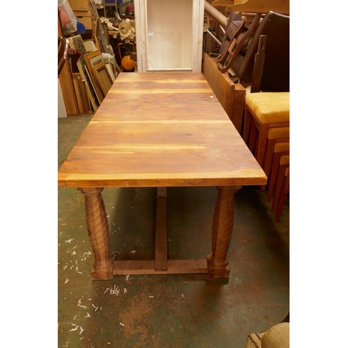 1211 - A bespoke yew wood refectory table with plank top, raised on twisted supports united by an H stretch... 