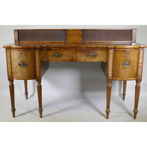 1213 - A George III mahogany sideboard with inverted front, the top with two tambour, front cupboards over ... 