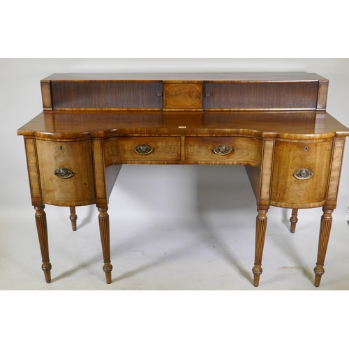 1213 - A George III mahogany sideboard with inverted front, the top with two tambour, front cupboards over ... 