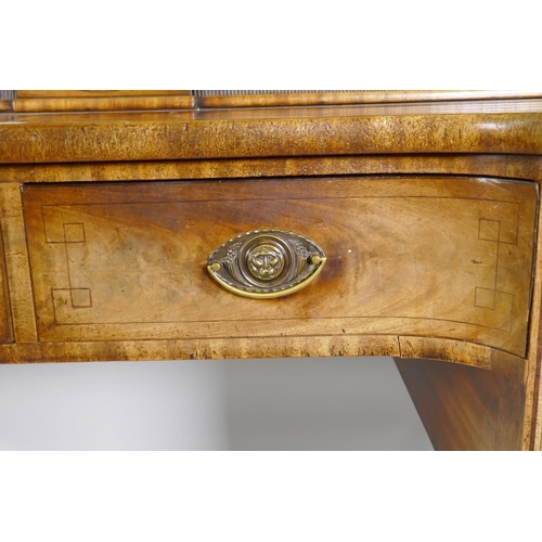 1213 - A George III mahogany sideboard with inverted front, the top with two tambour, front cupboards over ... 