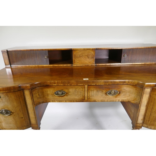 1213 - A George III mahogany sideboard with inverted front, the top with two tambour, front cupboards over ... 