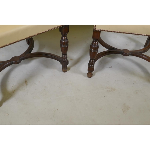 1216 - A pair of Continental oak show frame open arm chairs with leather upholstery and studded decoration,... 