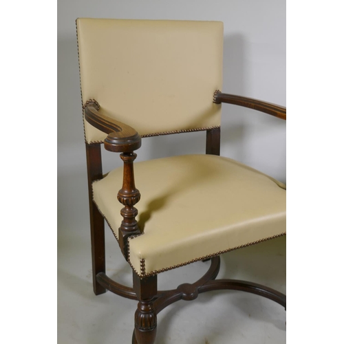 1216 - A pair of Continental oak show frame open arm chairs with leather upholstery and studded decoration,... 