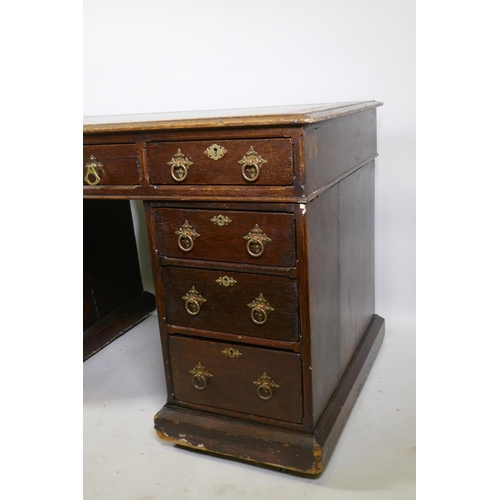 1224 - A Victorian oak on pine pedestal desk, with leather inset top, nine drawers with original brass hand... 