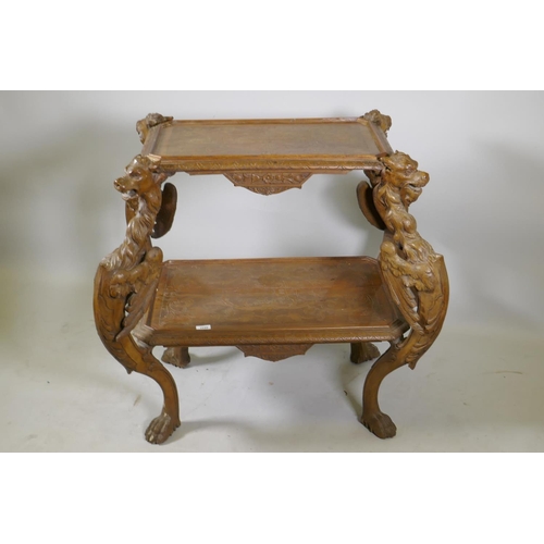 1238 - A C19th Continental walnut two tier etagere, with carved and incised decoration, raised on four wing... 