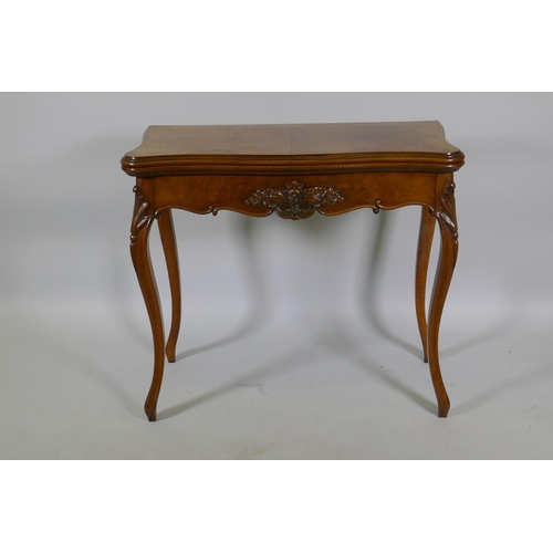 1240 - A Victorian serpentine shaped walnut card table with carved shaped frieze, raised on cabriole suppor... 