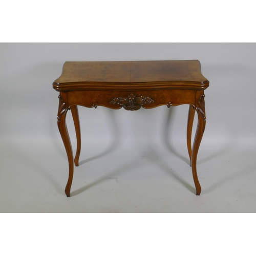 1240 - A Victorian serpentine shaped walnut card table with carved shaped frieze, raised on cabriole suppor... 