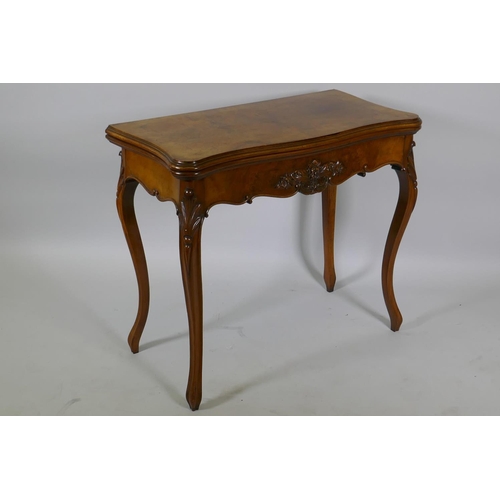 1240 - A Victorian serpentine shaped walnut card table with carved shaped frieze, raised on cabriole suppor... 