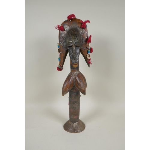 13 - An African wooden Bamana Janus puppet with decorative repousse metal mounts and shells, probably fro... 