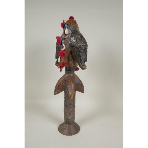 13 - An African wooden Bamana Janus puppet with decorative repousse metal mounts and shells, probably fro... 