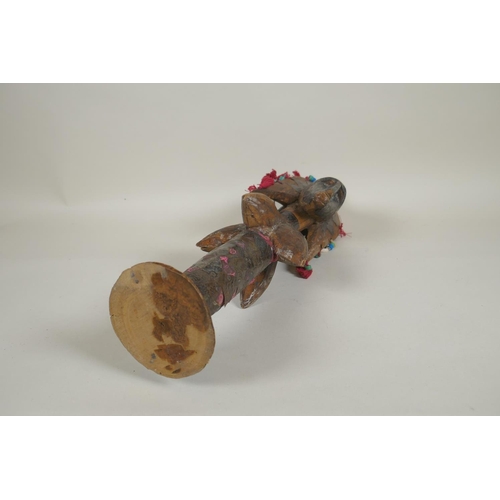 13 - An African wooden Bamana Janus puppet with decorative repousse metal mounts and shells, probably fro... 