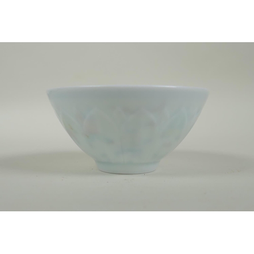 130 - A Chinese Doucai porcelain tea bowl of petal form, decorated with boys playing, 9cm diameter