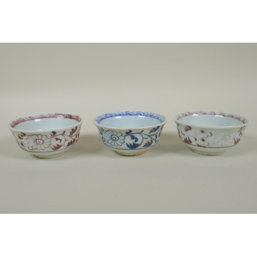 135 - A pair of Chinese Ming style red and white porcelain tea bowls decorated with flowers and phoenix, a... 