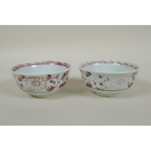 135 - A pair of Chinese Ming style red and white porcelain tea bowls decorated with flowers and phoenix, a... 