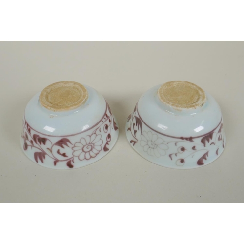 135 - A pair of Chinese Ming style red and white porcelain tea bowls decorated with flowers and phoenix, a... 