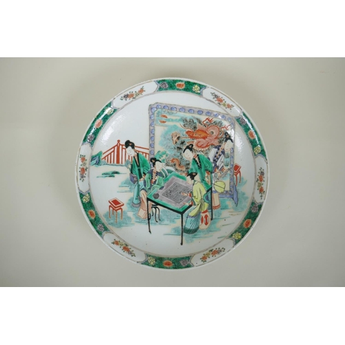 140 - A Chinese kangxi style famille verte porcelain charger decorated with women playing go, leaf mark to... 