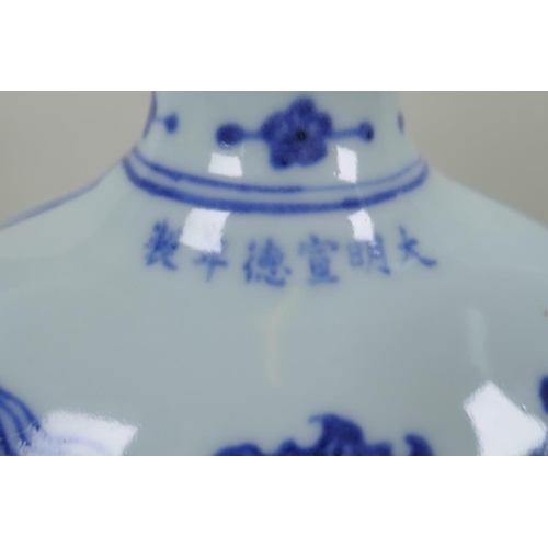 145 - A Chinese blue and white porcelain two handled moon flask with dragon decoration, Xuande 6 character... 