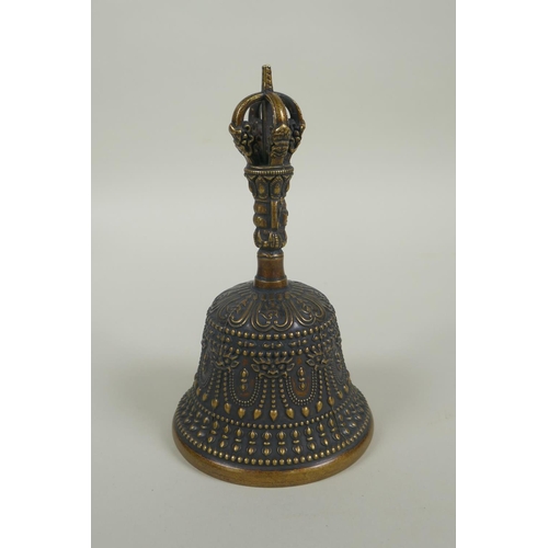 150 - A Tibetan ceremonial bronze bell with a vajra handle, 15cm high